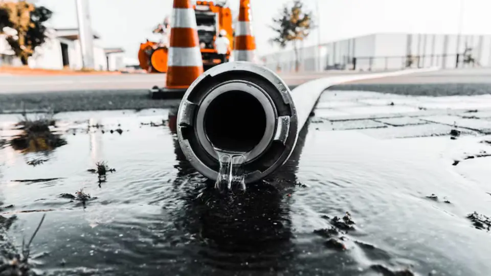Discharge hose of a water pump lying in a flooded area